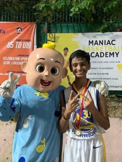 A player proudly shows off his medal at "The Carnival." We celebrate every achievement and make our events memorable for everyone.
