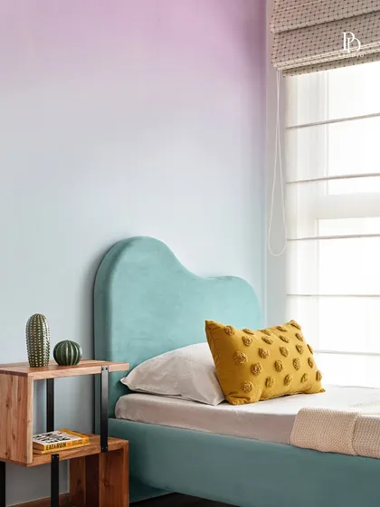 Designing for families means creating spaces that are both playful and practical. In this child's bedroom, I used a soft, ombre-painted wall and a custom-designed bed to create a whimsical atmosphere. The color palette is cheerful yet calming, making it a perfect room for a child to grow into.