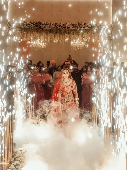 A dramatic bridal entry through a cloud of smoke and a tunnel of sparklers. This is how you make an unforgettable entrance, and I am there to capture it.