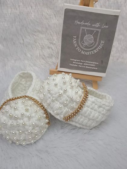 A different view of the white pearl booties with the stone-studded strap, showing their elegant and luxurious design.