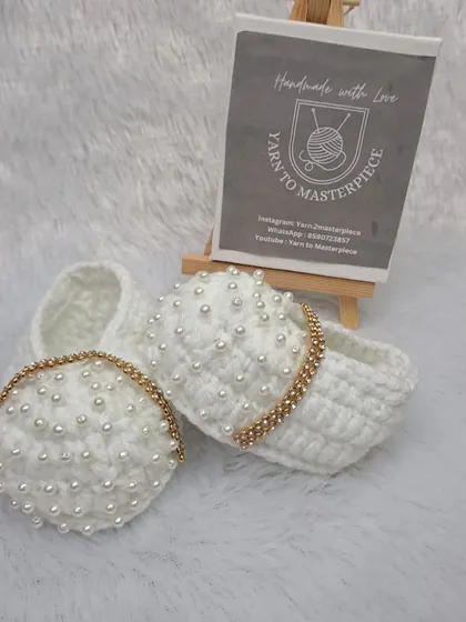 A different view of the white pearl booties with the stone-studded strap, showing their elegant and luxurious design.