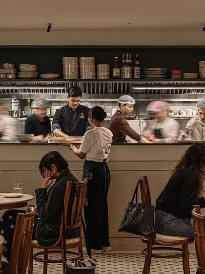 I always wanted Kopitiam Lah to have the lively, bustling energy of a real Malaysian coffee shop. Here you can see my amazing team at work in our open kitchen, preparing authentic dishes for our guests. The sounds and smells are all part of the experience.