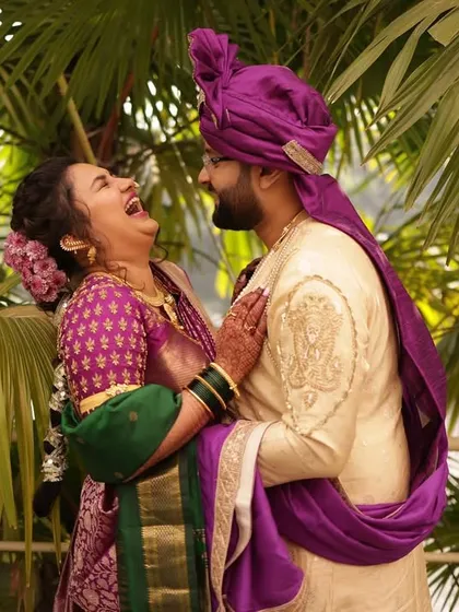 Laughter and love are the best accessories. This candid photo shows the couple sharing a joyful moment, highlighting the comfort and beauty of their coordinated wedding attire.