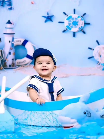 A happy sailor boy in his boat, surrounded by a sea of blue and friendly sharks.