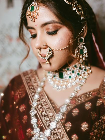 A beautiful, artistic shot focusing on the intricate jewelry and the soft, smokey eye makeup.
