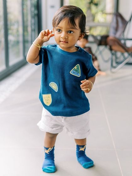 A candid shot of a one-year-old boy during his birthday celebration at home. These are the real-life moments that tell your family's story.