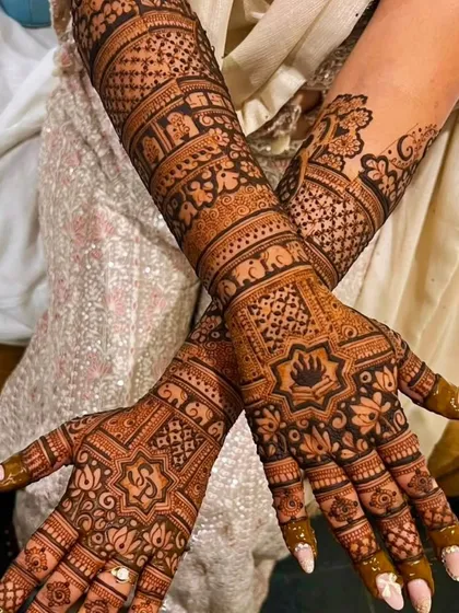 An elegant bridal design with a mix of geometric and traditional motifs, including elephants and floral patterns.