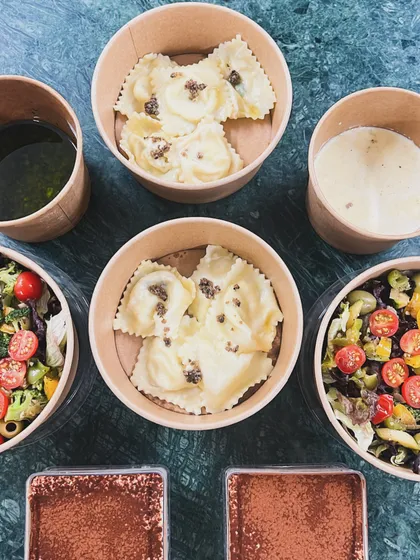 A complete Italian meal, packed and ready for delivery. This order included my handmade truffle ravioli, a fresh salad, and individual portions of tiramisu for dessert.