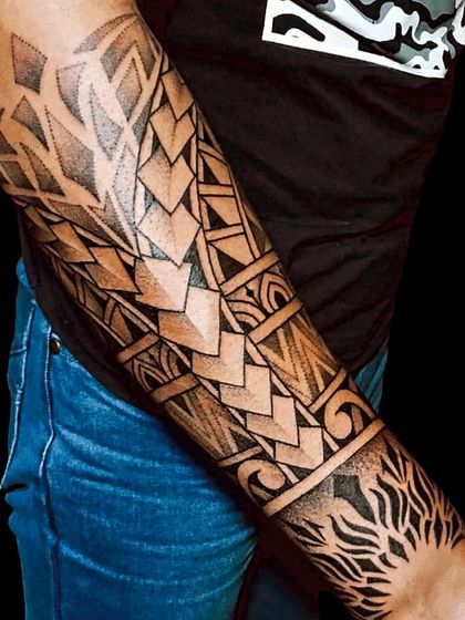 A Polynesian-inspired forearm sleeve. This design features geometric patterns and sharp, clean lines, creating a bold and modern take on tribal art.