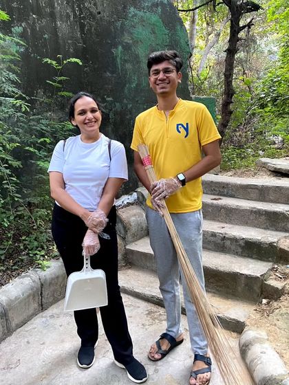 A photo of our instructor and a young volunteer, ready with their cleaning tools. It's inspiring to see all generations participate.
