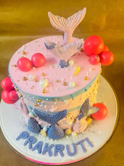 Dive into a magical underwater world with our mermaid-themed cake. This design features beautiful mermaid tails, pearls, and an ocean-inspired color palette.