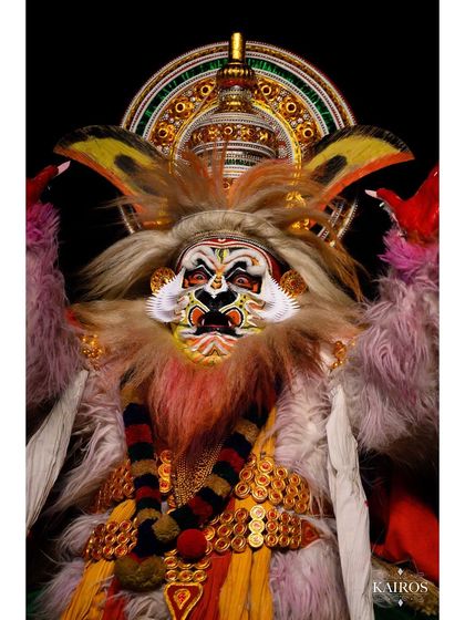 A powerful, confrontational pose from a Kathakali performance, capturing the character's fierce energy.