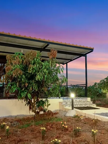 A container home at Suzo Farms at twilight, with warm lights glowing from its porch. The image evokes a sense of peace and comfort, showcasing the home as a perfect evening retreat.