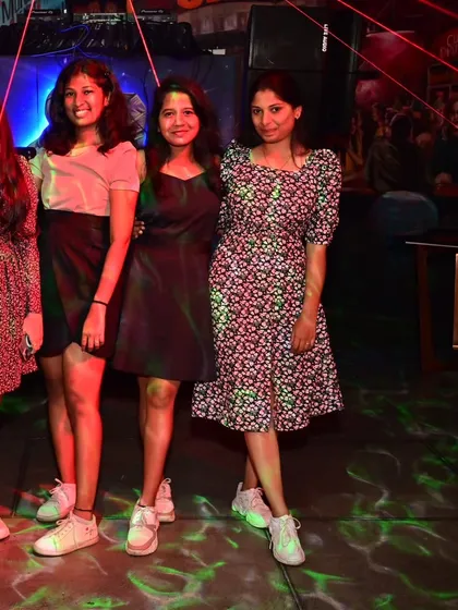 A group of friends posing for a picture during a fun night out.
