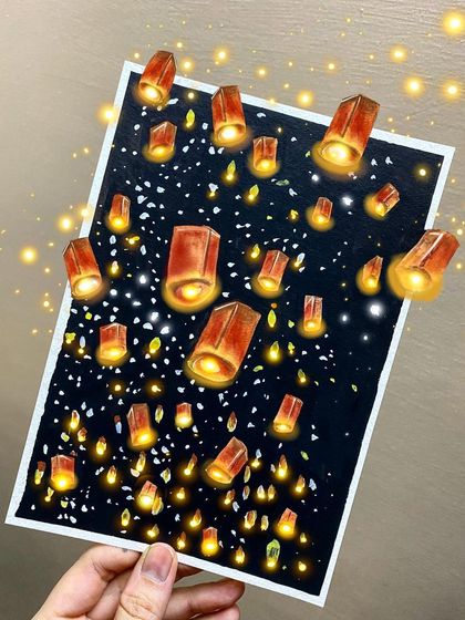 A magical night scene filled with glowing lanterns floating in the sky. I used markers and white paint on black paper to make the lanterns appear as if they are really lit from within.