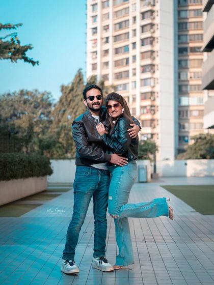 A playful and fun pose during the urban shoot. This photo captures the couple's happy and carefree personality against a modern city background.