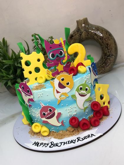 Baby shark doo doo doo doo. This cute and colorful baby shark cake was for a 2nd birthday, featuring the whole shark family and underwater details.
