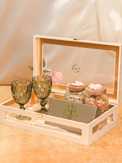 A sophisticated Rakhi gift for a brother with fine taste. This wooden keepsake box includes two beautiful goblets, jars of premium nuts, and a traditional envelope for your Rakhi message.