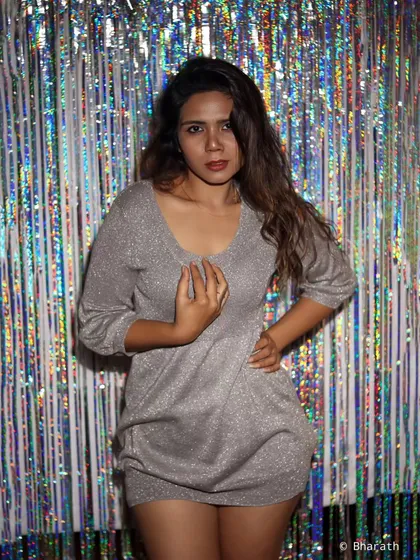 A confident, straight-on portrait that highlights the party-wear theme.