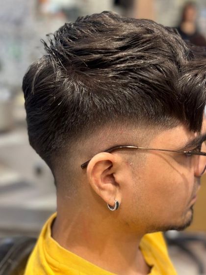 A side profile of the men's fade haircut, showcasing the clean lines and expert blending.