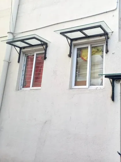 A finished view of two window awnings and a door awning I fabricated and installed. The black metal frame provides a modern, clean look while being highly functional.