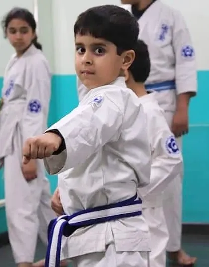 We teach our youngest students that true strength begins with focus. This young karateka demonstrates the concentration and discipline we instill in our kids' karate classes.