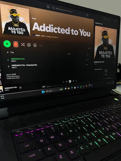 This is the setup. My Alienware laptop, a pair of headphones, and my original Afro House track 'Addicted to You' ready to go on Spotify. This is where the bangers are born, whether I'm at home or on the road.