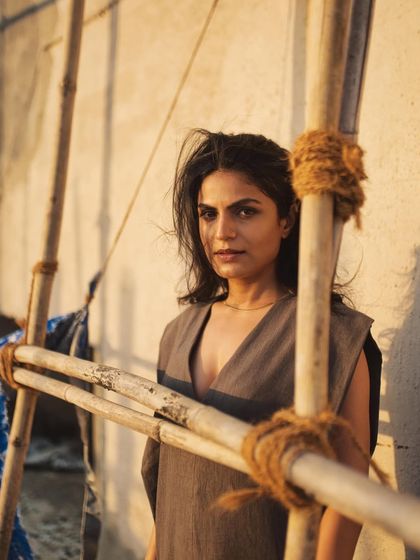 Using the bamboo scaffolding as a framing device, this shot adds a raw, textural element to the portrait series.