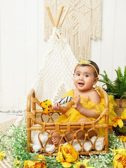 A sunny, boho-inspired sitter session. This baby girl is surrounded by sunflowers and natural textures, creating a bright and cheerful atmosphere.