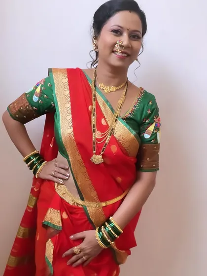 A full-length view of the red nauvari saree. The draping is done perfectly to ensure comfort and grace, allowing the bride to move with ease.