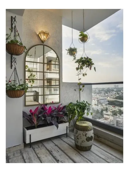 This balcony at Peninsula Heights uses a mix of hanging baskets, planters, and a large mirror to create a sense of depth and lushness. The design maximizes the small space, turning it into a vibrant, sky-high garden.