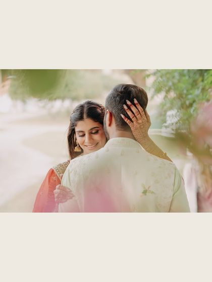 An artistic and intimate portrait. Captured from behind the groom, this shot focuses on the bride's serene expression and gentle touch, creating a soft, romantic, and personal moment.