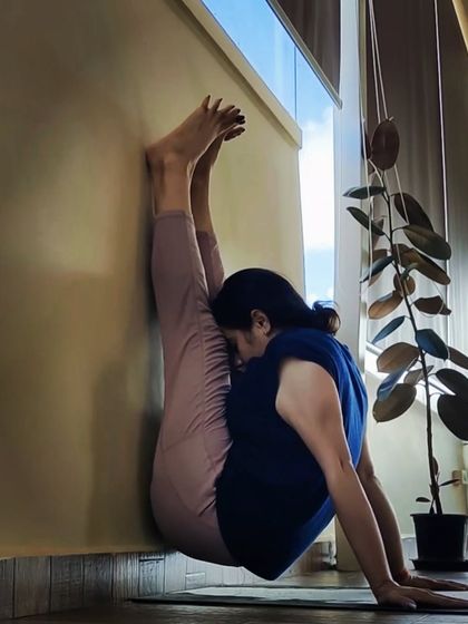 Using the wall for support in this intense forward bend helps to deepen the stretch in the hamstrings and spine safely.