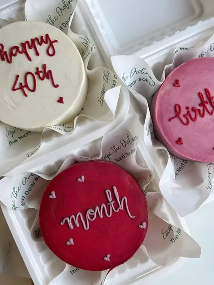 A trio of colorful mini cakes for celebrating monthly milestones and a 40th birthday. Each one has a simple, heartfelt message piped on top.