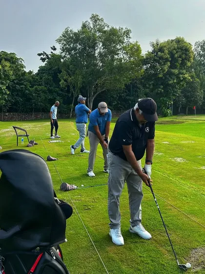 A close-up of golfers in the zone, with their bags lined up and ready for the next club selection.