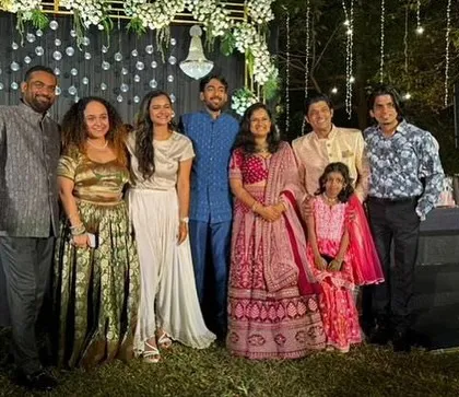 A group photo with the couple and their close friends and family, capturing the joy of the wedding.