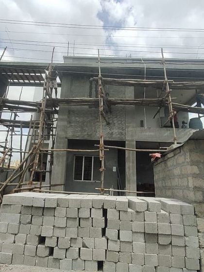The same house during the construction phase, with the core structure and scaffolding in place. This shows the project in progress.