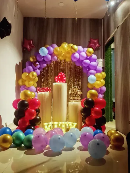 We also decorate for smaller events like kitty parties. This colorful setup with a shimmer curtain and balloon arch is ready for a fun get-together.