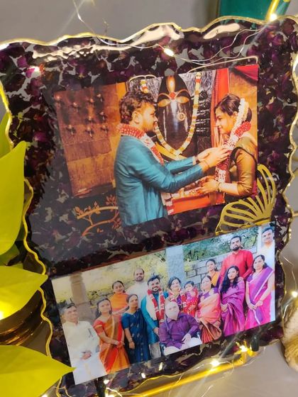 For this custom resin frame, I used the couple's varmala flowers to create a rich, dark border around their favorite wedding and family photos. The added fairy lights make it glow.