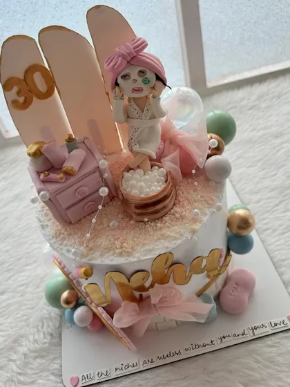 This was one of my most detailed cakes, a "spa day" theme for a 30th birthday. It features a hand-sculpted figure with a face mask, a mini vanity, and lots of pampering details.