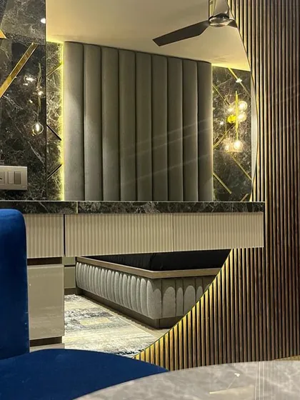 This vanity area in the Juhu home is a study in texture and reflection. I combined dark marble with gold inlay, fluted wood panels, and strategic lighting to create a glamorous and functional space.