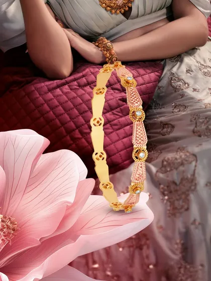 This dual-toned gold and diamond bangle is designed to wrap the wrist in shimmer and sophistication. It is a versatile piece, perfect for a bride's trousseau, blending tradition with modern style.
