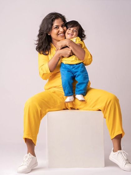 A mother and son, both shining bright in yellow. This fun and vibrant portrait is full of energy and happiness.