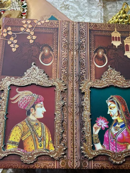 For a love story that feels like royalty, I designed this invitation inspired by timeless Indian miniature art. The Raja-Rani window portraits, set against a rich, textured background, create a regal and intimate announcement for your grand celebration.