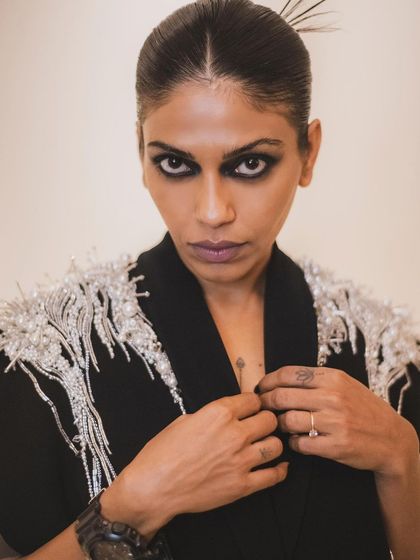 Another angle of Anasuya's powerful look, focusing on her intense gaze and the intricate details on her outfit's shoulders.