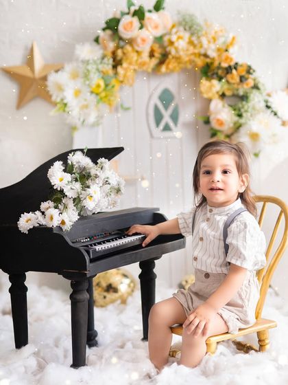 A little musician in a magical, starry world. The combination of the miniature piano and the celestial theme creates a beautiful and imaginative scene.