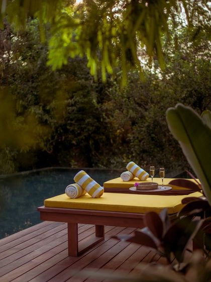 A quiet corner by the pool, with champagne flutes ready for a celebration or a simple moment of indulgence.