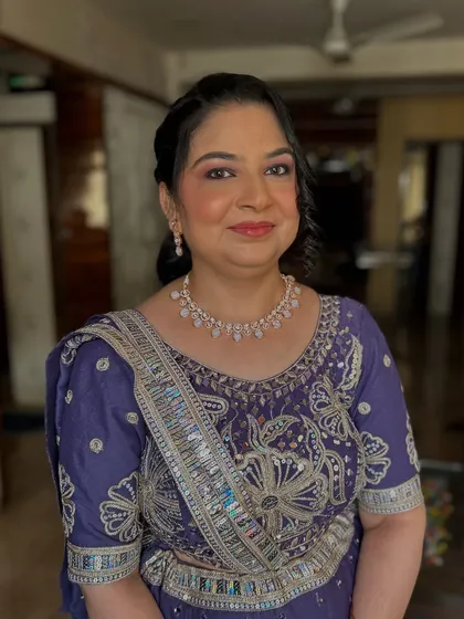 A beautiful makeover for a client in a purple lehenga. The makeup features a soft purple smokey eye and a radiant base.