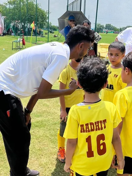A coach giving a pre-game talk to his team during the Pride Cup Tournament. This moment captures the enthusiasm and sportsmanship we aim to inspire in every player.