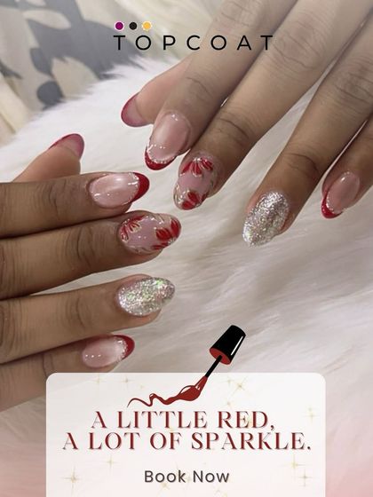 A little red, a lot of sparkle. This design combines a red French tip with hand-painted red flowers and a full silver glitter accent nail for a look that is both glamorous and festive.